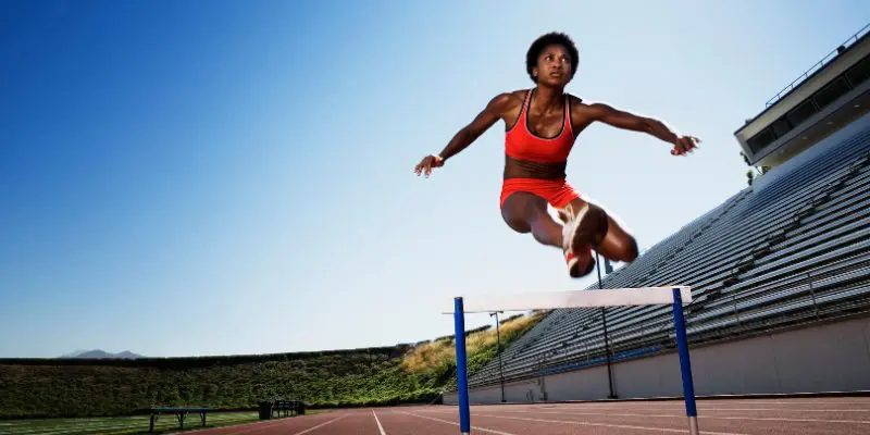 Hurdler jumps over barrier