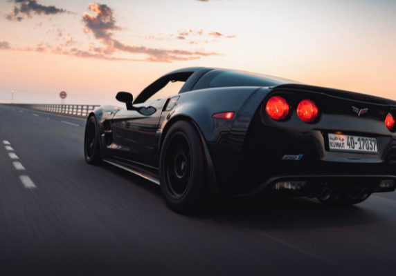 Corvette driving toward the sunset