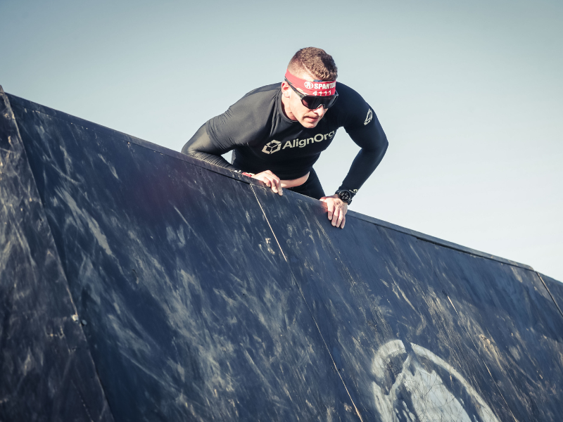 Luke Wilding climbs an obstacle during an April 2025 Spartan Race.