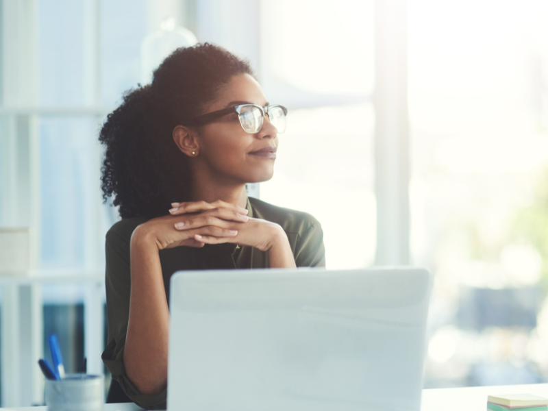 A smiling office worker - someone who believes in the organization transformation.