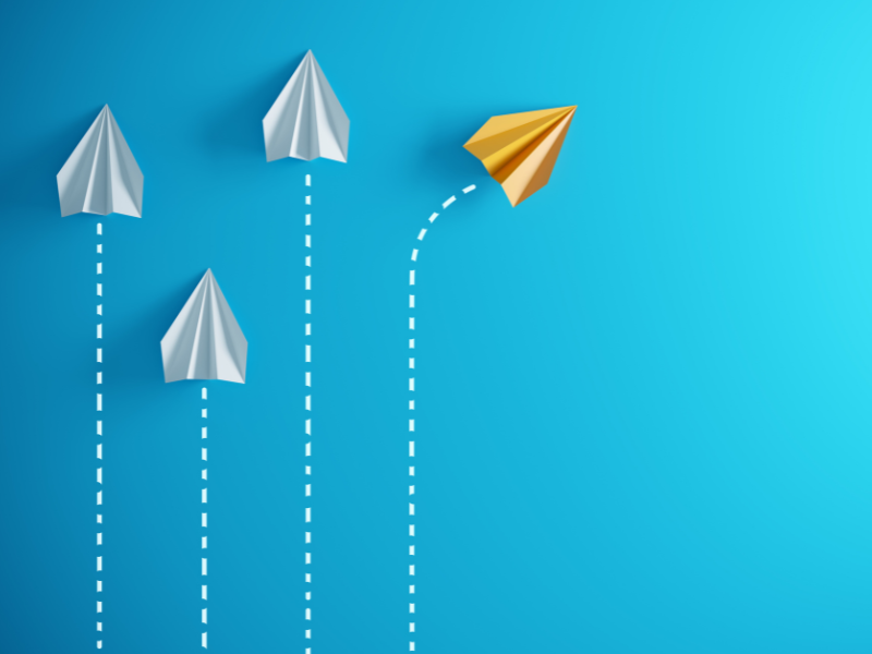 three paper airplanes, with a fourth out of alignment