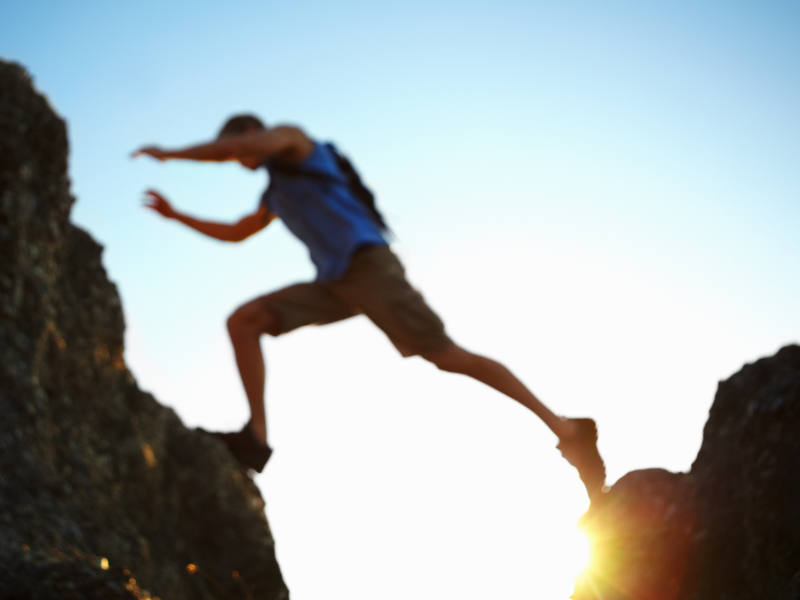 Man jumping over rocks